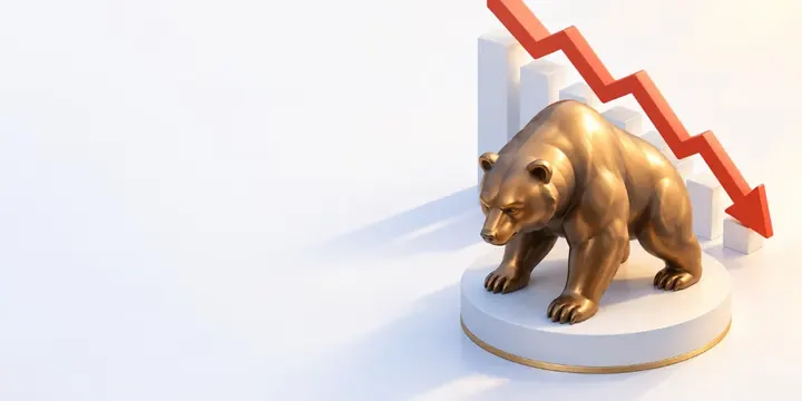 Bronze bear statue with a descending red chart behind it
